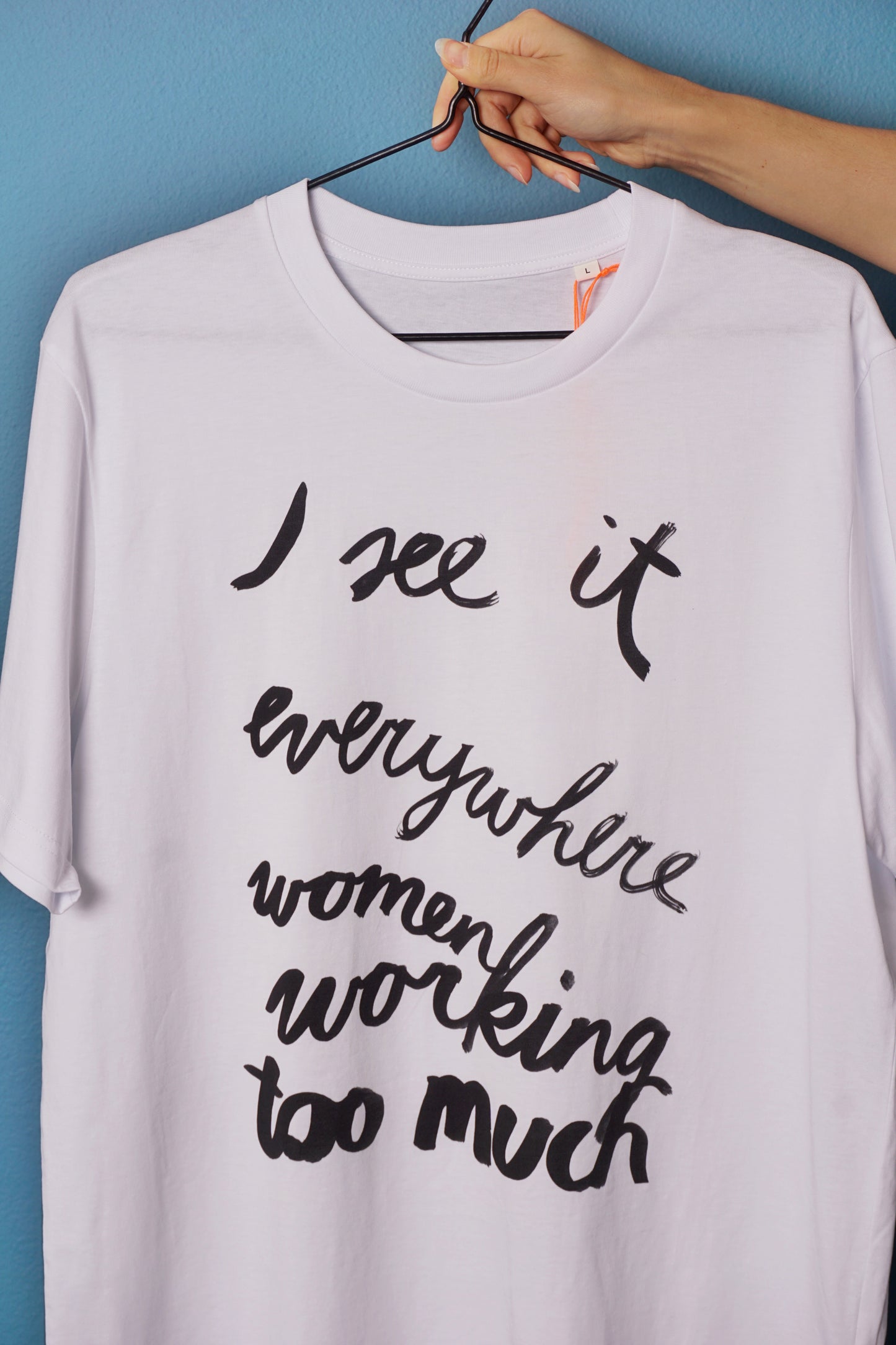 Eva Vēvere. Unisex T-Shirt "I see it everywhere women working too much"